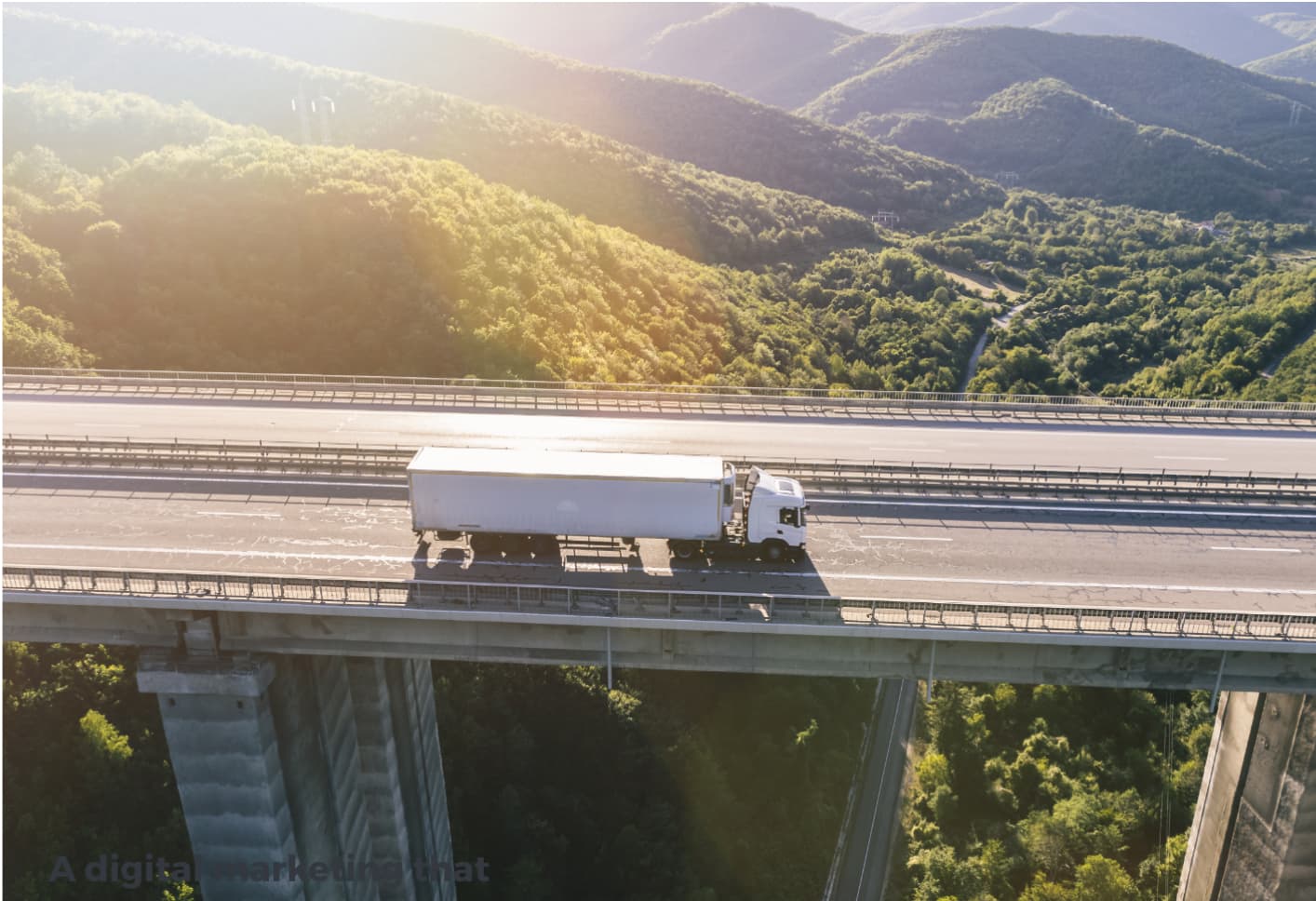 A lorry on a bridge at sunset